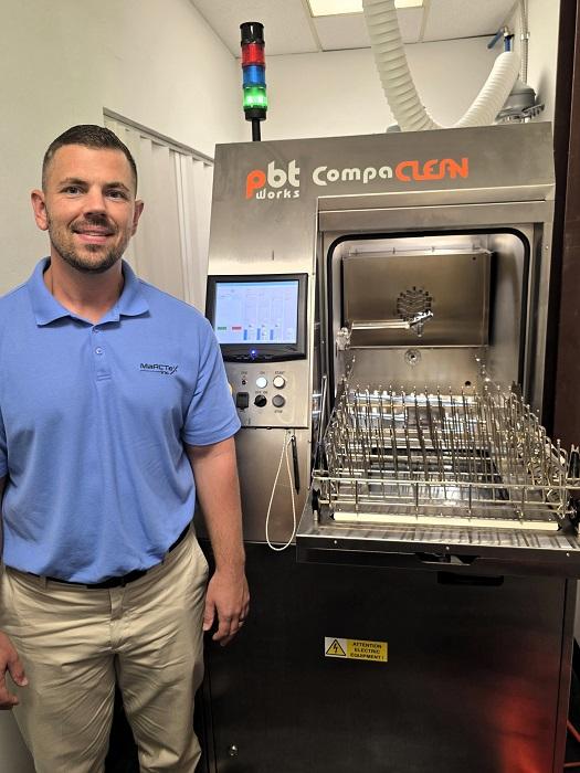 picture of man next to equipment